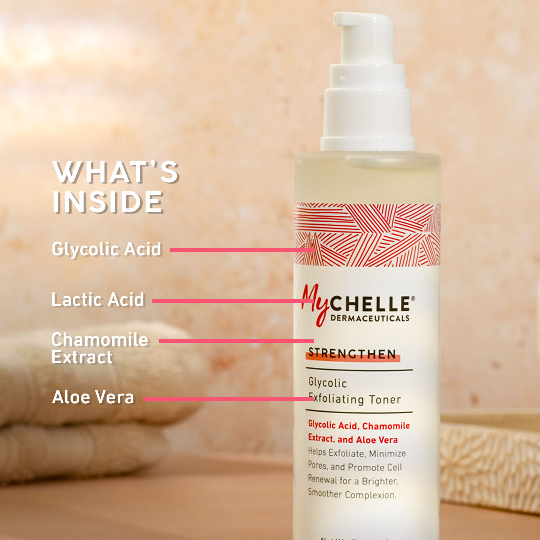 A bottle of Mychelle Dermaceuticals Glycolic Exfoliating Toner stands on a wooden surface against a warm beige background. Pink lines and text on the left list ingredients: Glycolic Acid, Lactic Acid, Chamomile Extract, and Aloe Vera.