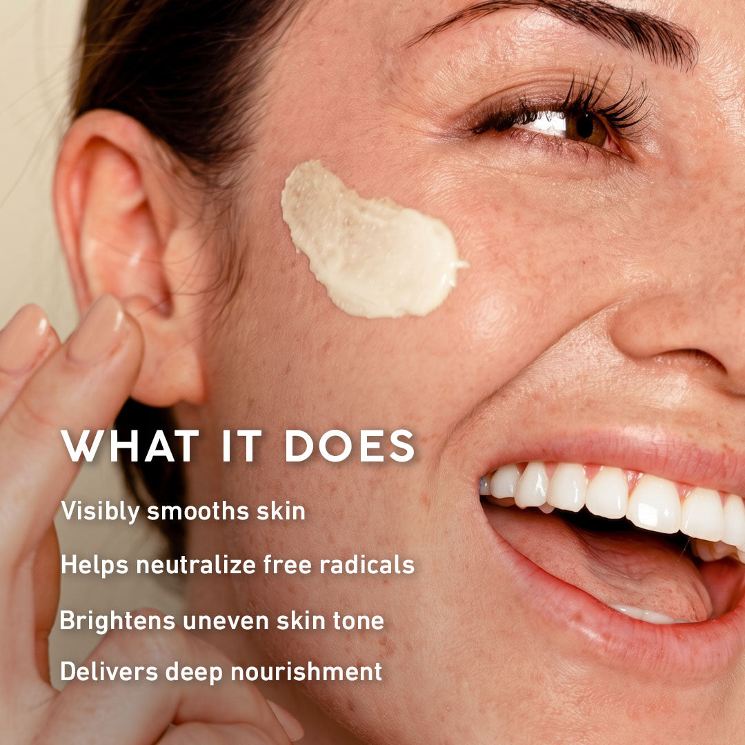 Close-up of a woman's face with a dollop of cream cosmetic product on her cheek and overlaid text reading 'WHAT IT DOES' followed by skincare benefits.