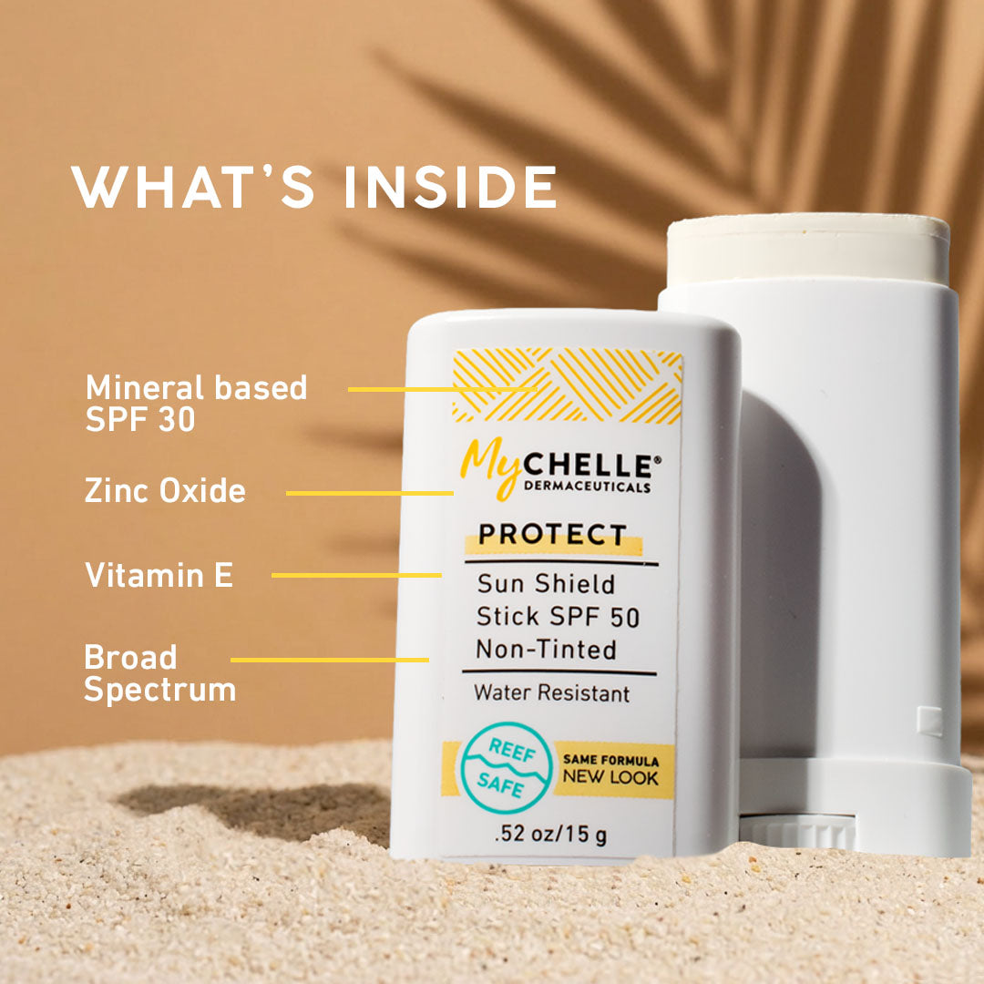 MyChelle Dermaceuticals Sun Shield Stick SPF 50 on sand with product details.