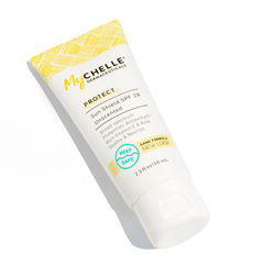 A tube of MyChelle Sun Shield SPF 28 Unscented with yellow and white design on a white background