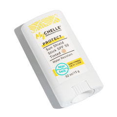 MyChelle Sun Shield Stick SPF 50 with a tinted finish and water-resistant feature - shown as a stick dispenser with yellow and black text detailing displayed on a white background.